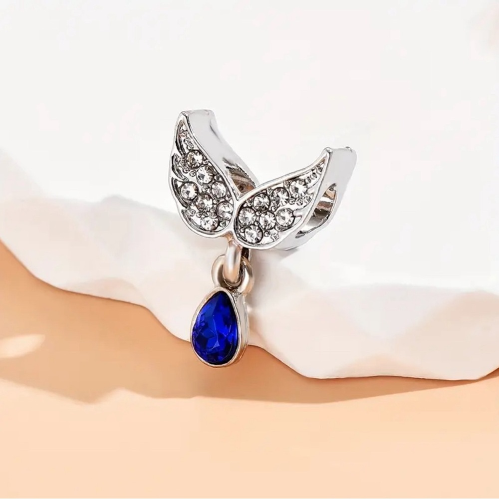 New Silver-tone angel wings with teardrop-shaped deep blue stone